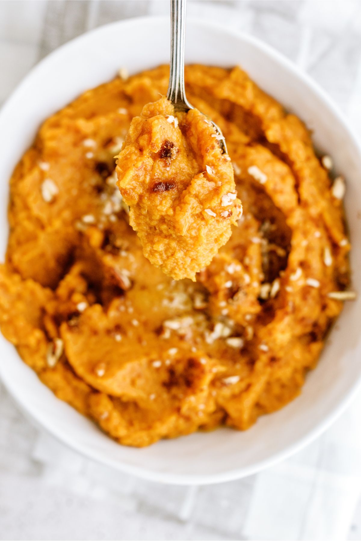 Top view of Mashed Sweet Potatoes with a spoon