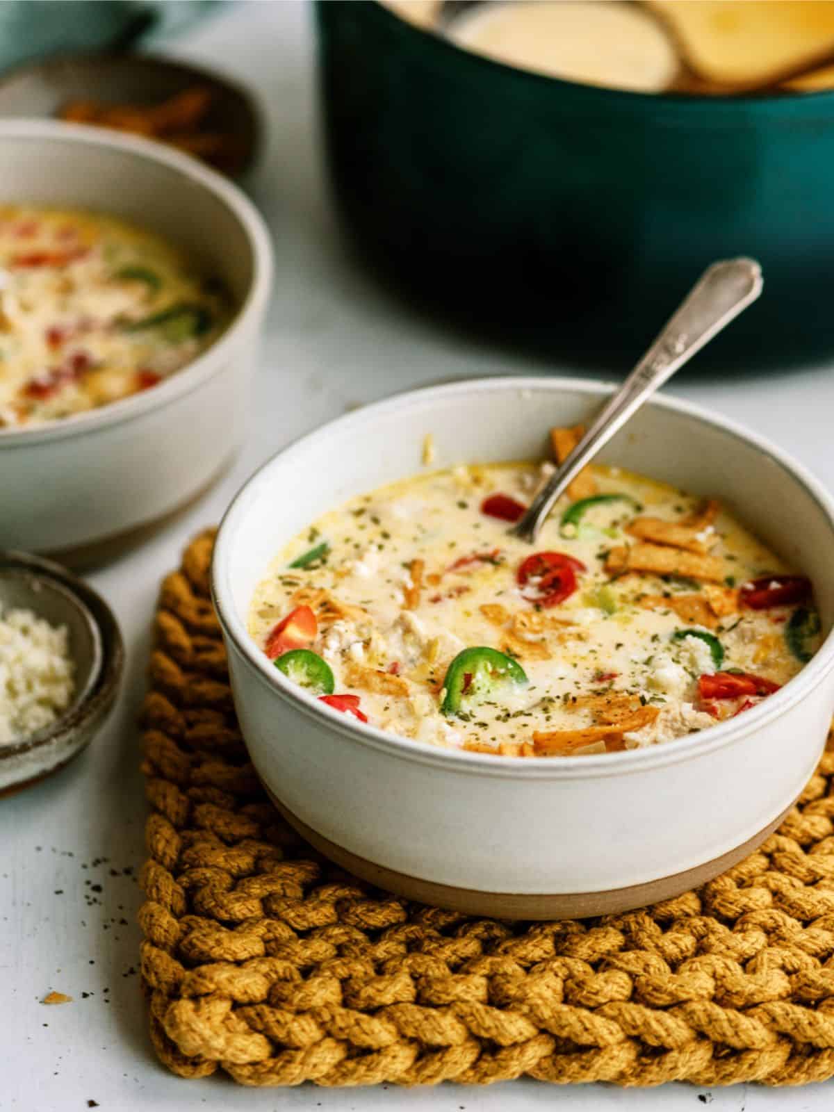 A serving of Mexican Cheesy Chicken Corn Chowder in a bowl with a spoon