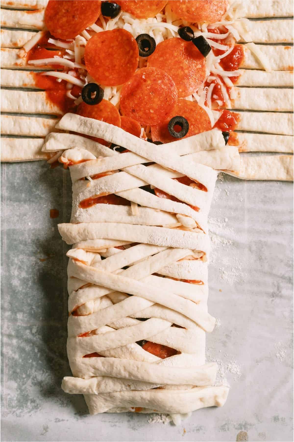 Strips of dough layered across the middle of the dough.