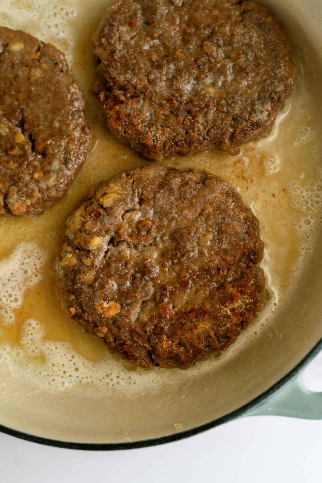 Hamburger patties in skillet