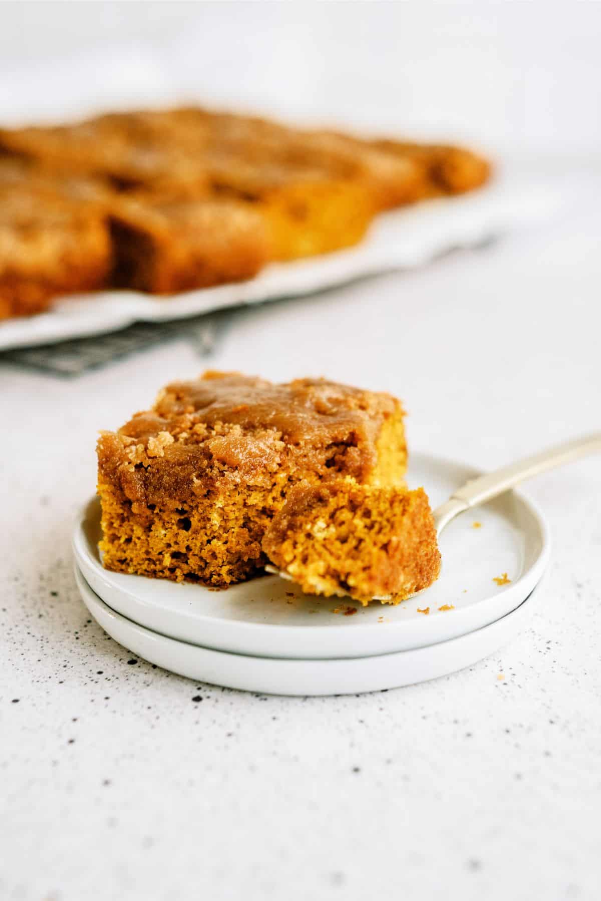 A slice of Pumpkin Coffee Cake with Brown Sugar Glaze on a plate