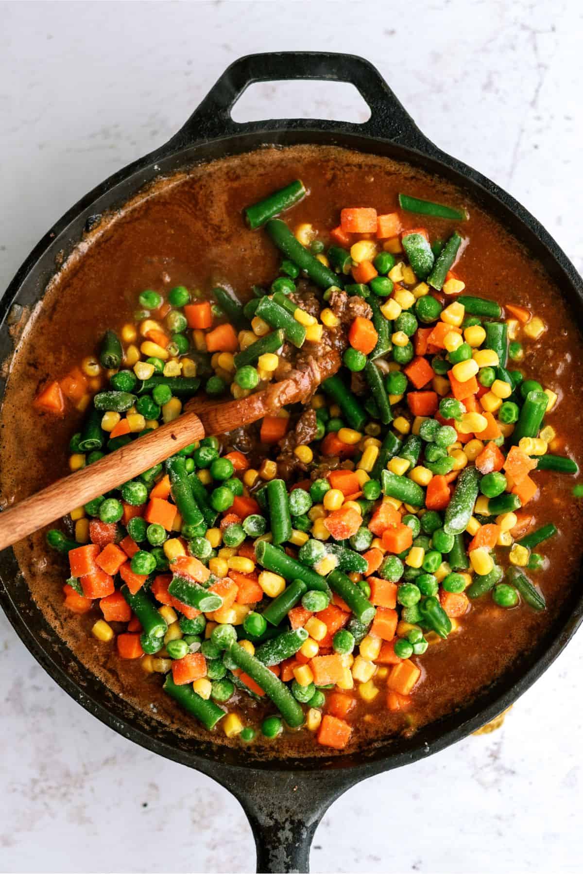 Frozen vegetables added to meat mixture