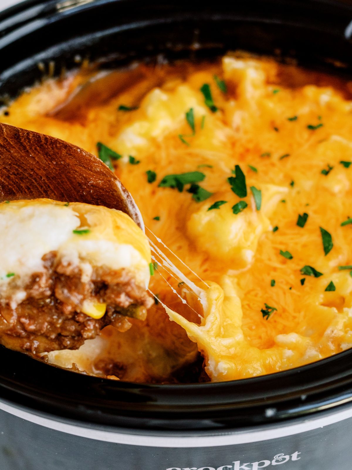 Slow Cooker Ground Beef Shepherd’s Pie topped with cheese in the slow cooker