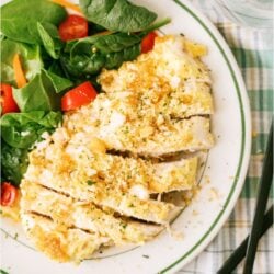 Slow Cooker Ritz Chicken on a plate with a side of salad.