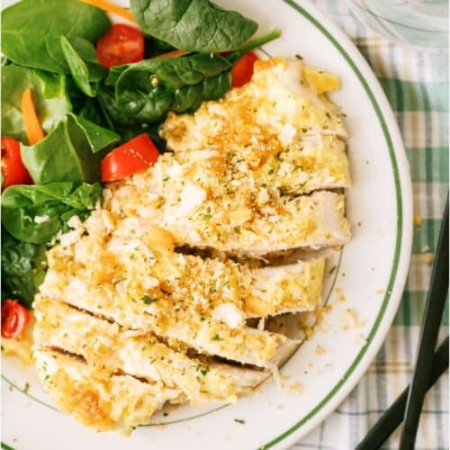 Slow Cooker Ritz Chicken on a plate with a side of salad.