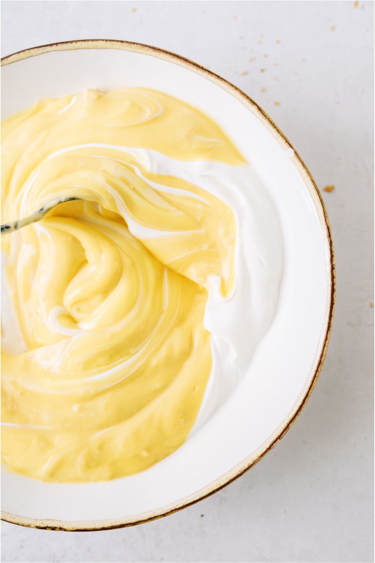Mixing soup and sour cream together in a bowl.