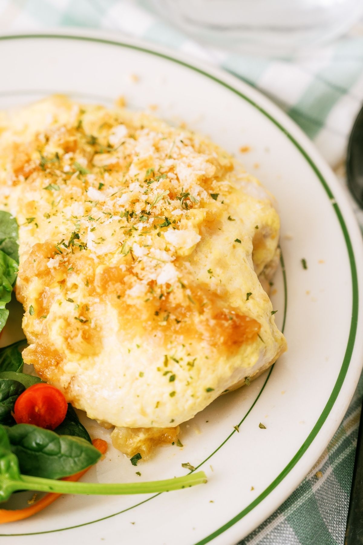 Slow Cooker Ritz Chicken on a plate with salad on the side.
