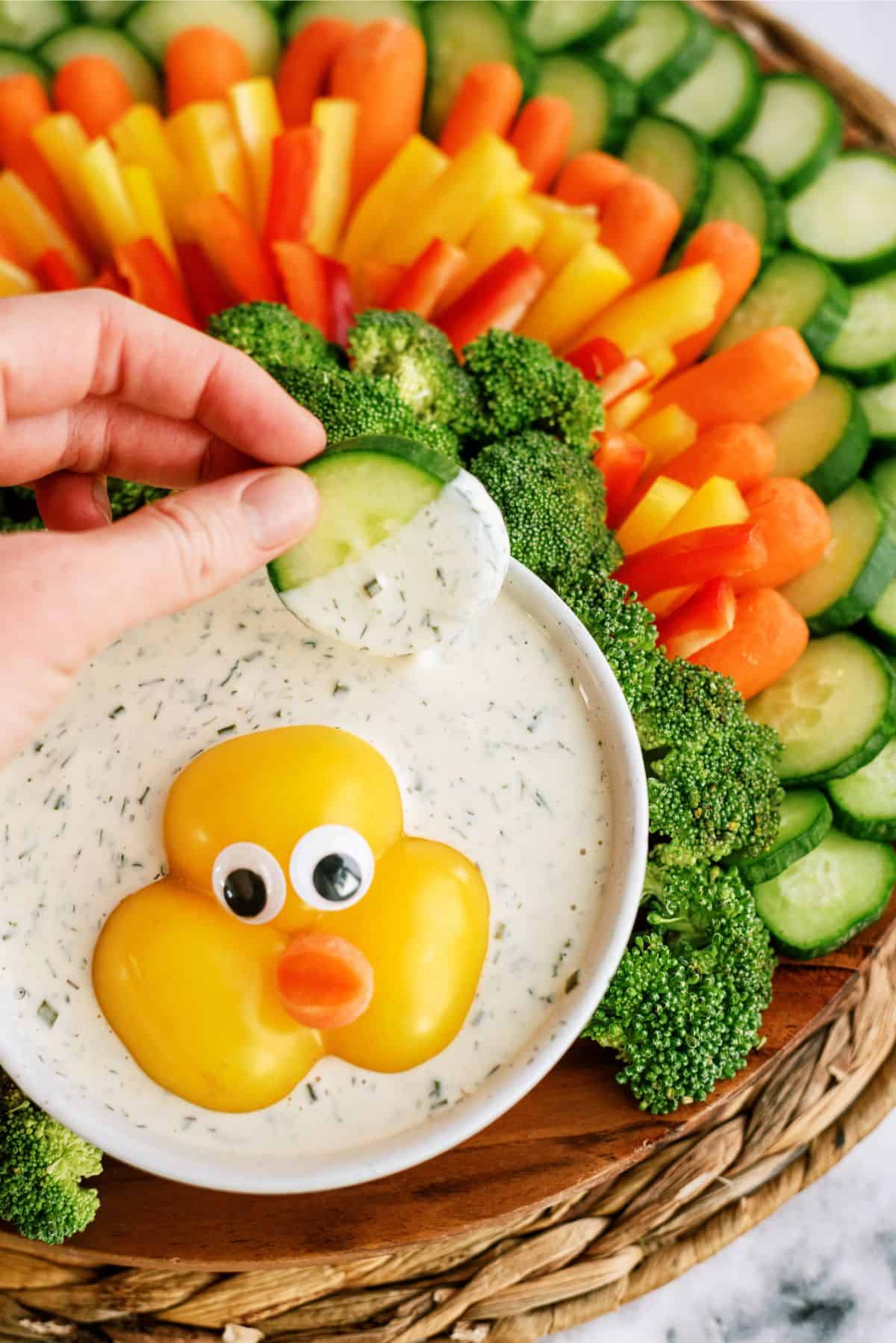 Thanksgiving Turkey Vegetable Tray Recipe and Homemade Ranch Dip with a cucumber being dipped into the ranch