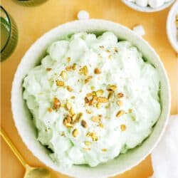 Top view of a serving bowl of 5 Minute Pistachio Salad with a small bowl of mini marshmallows off to the side.