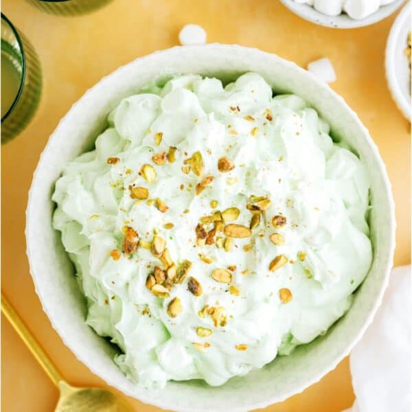 Top view of a serving bowl of 5 Minute Pistachio Salad with a small bowl of mini marshmallows off to the side.