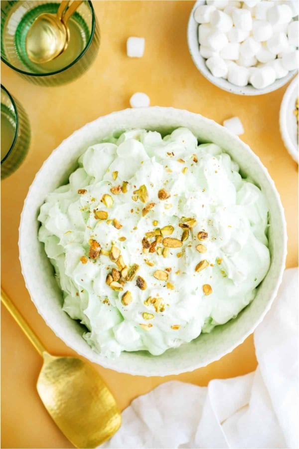 Top view of a serving bowl of 5 Minute Pistachio Salad with a small bowl of mini marshmallows off to the side.