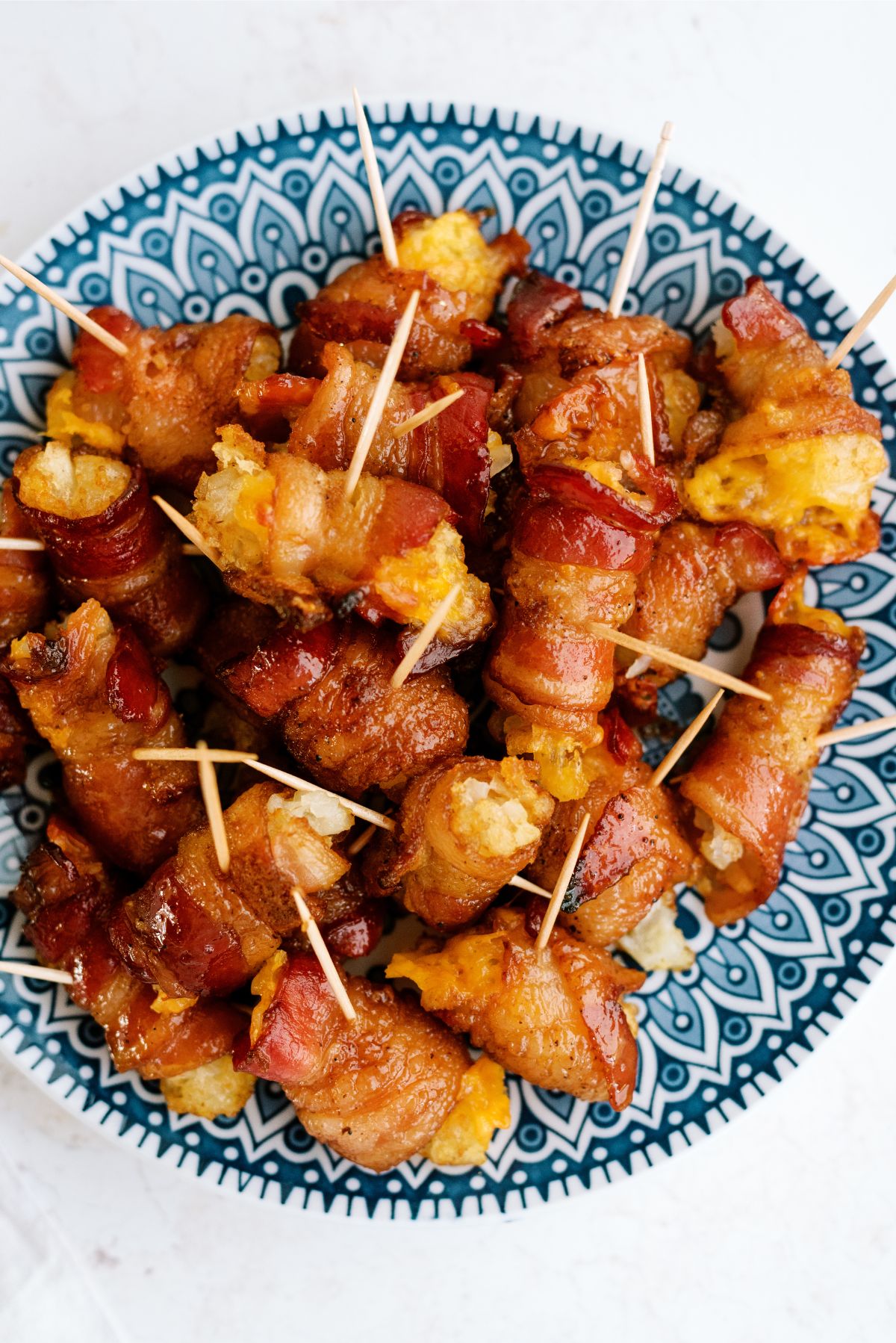 Bacon Wrapped Tater Tots with Cheese on a plate