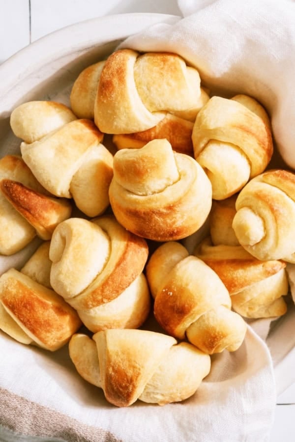 Top view of a basket full of Freshly Baked Easy Homemade Rolls.