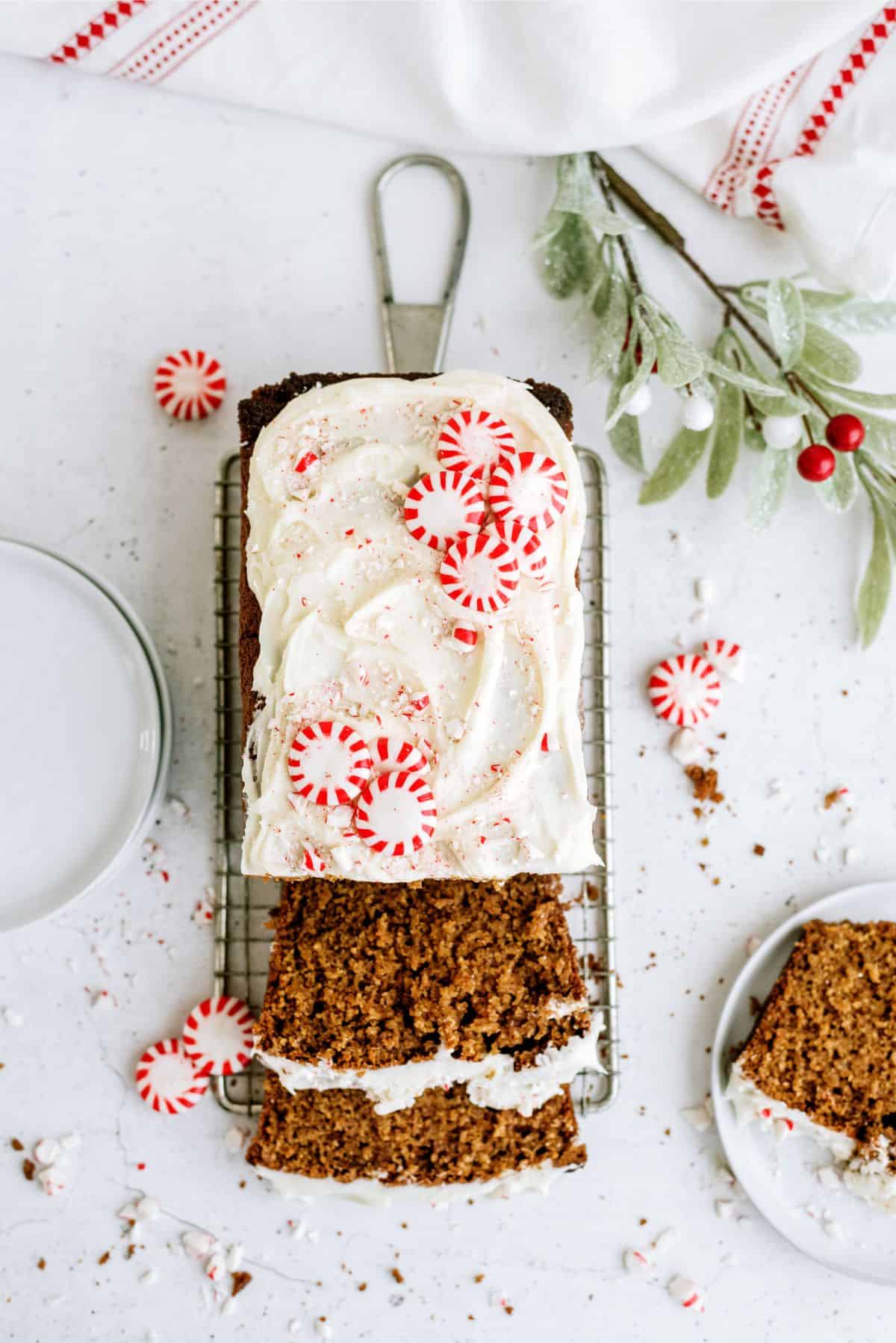 Frosted Gingerbread Pound Cake sliced on a cooling rack