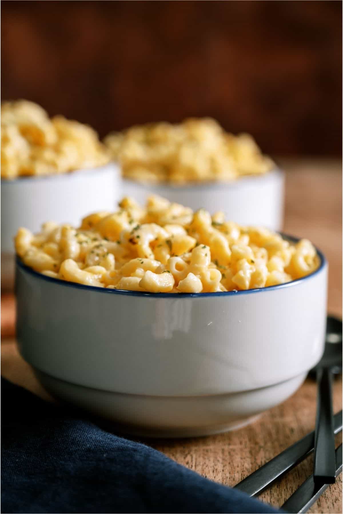 Three bowls with servings of Instant Pot Creamy Macaroni and Cheese.