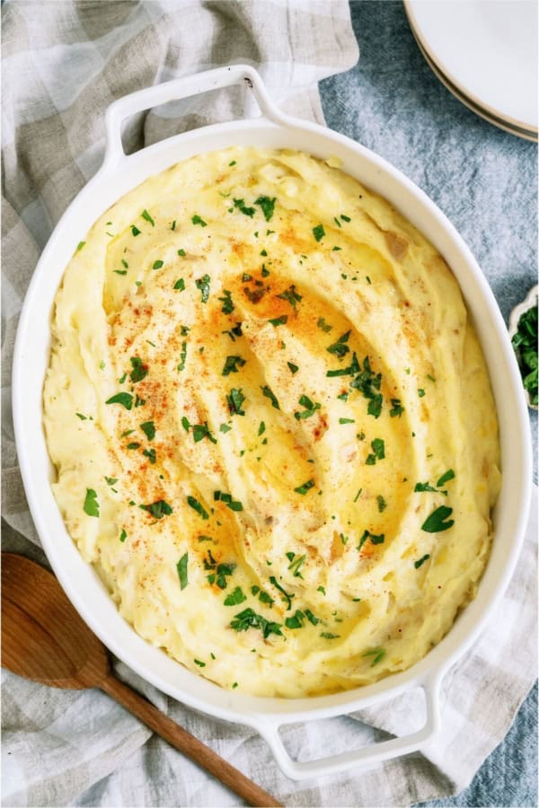 Make-Ahead Mashed Potatoes in a white casserole dish.