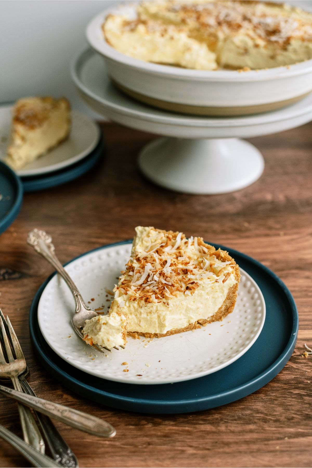 A slice of No Bake Coconut Cream Pie on a plate with a fork