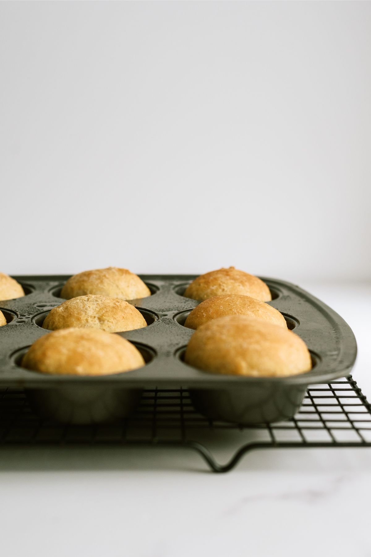 Cooked No Knead Honey Wheat Dinner Rolls in muffin tin