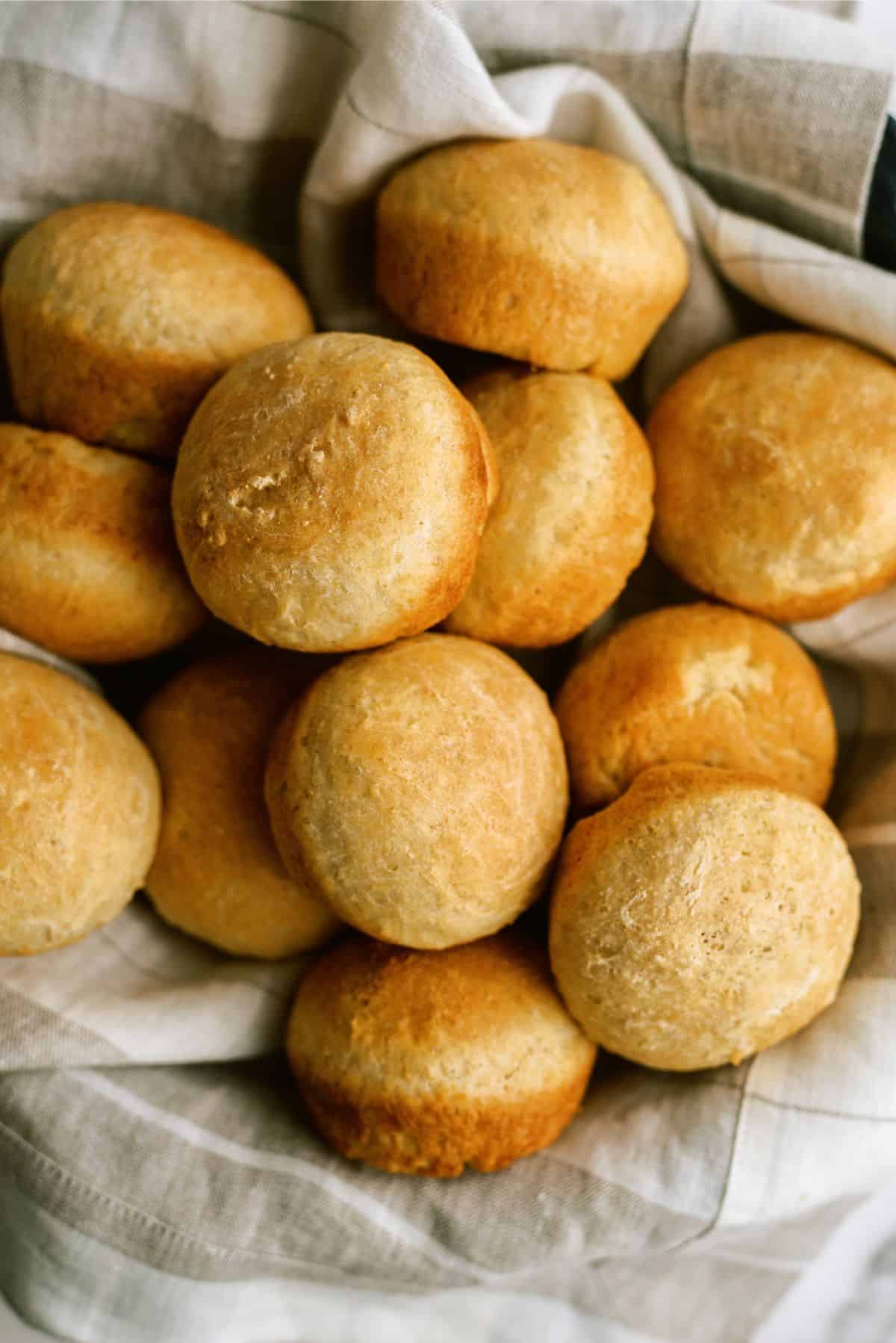 A basket full of No Knead Honey Wheat Dinner Rolls