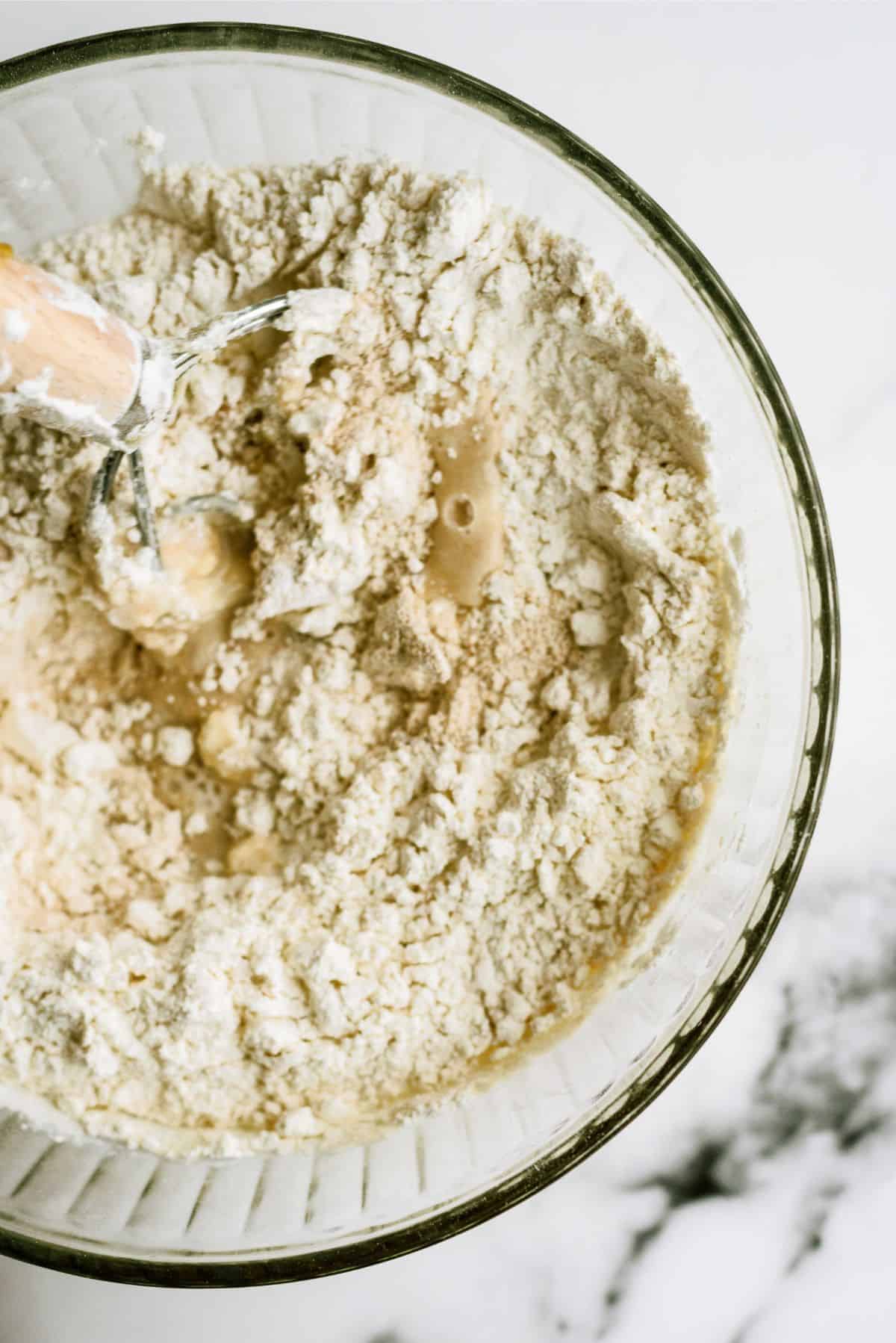 No Knead Honey Wheat Dinner Roll dough ingredients in a mixing bowl