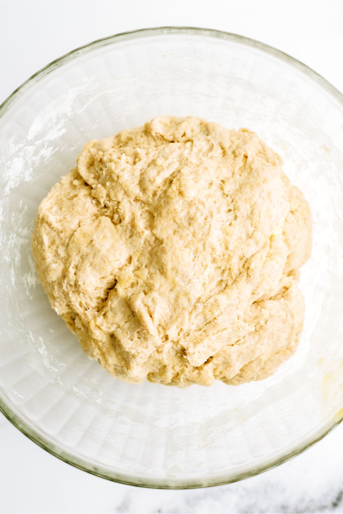 No Knead Honey Wheat Dinner Rolls dough risen in bowl