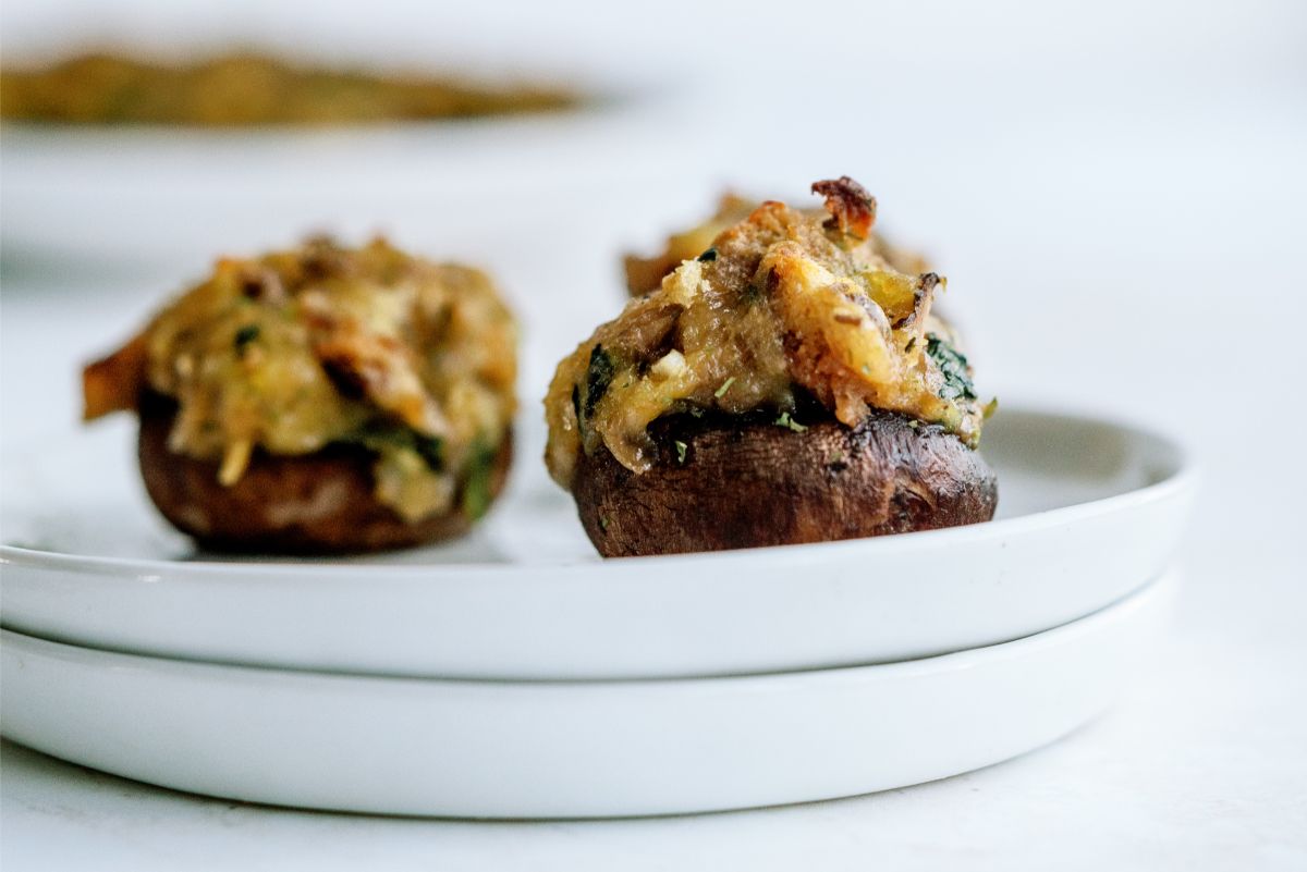 Close up of 2 Parmesan Spinach Stuffed Mushrooms on a plate