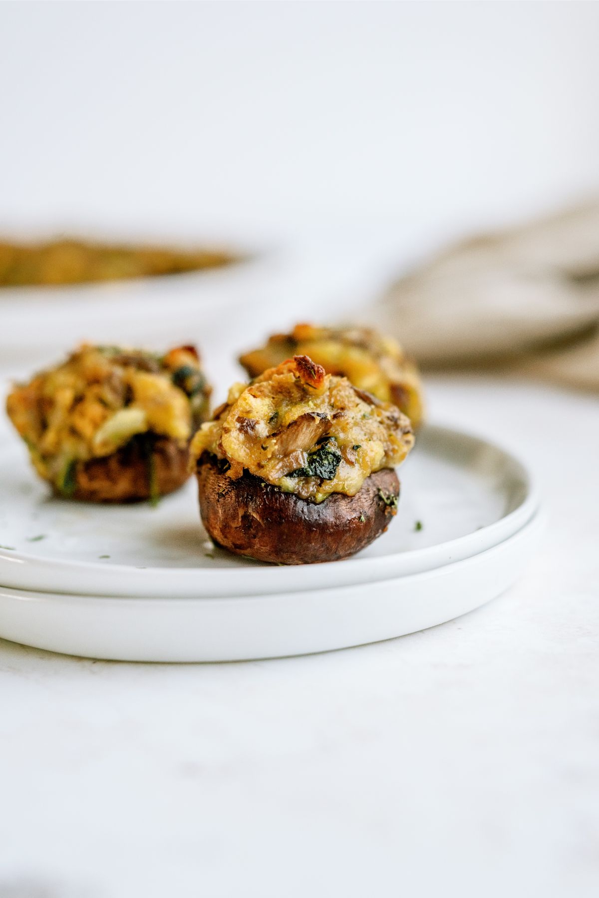 3 Parmesan Spinach Stuffed Mushrooms on a plate