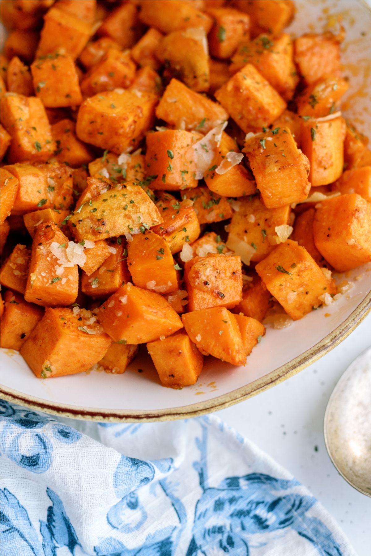 Close up of Roasted Parmesan Sweet Potatoes in a serving bowl