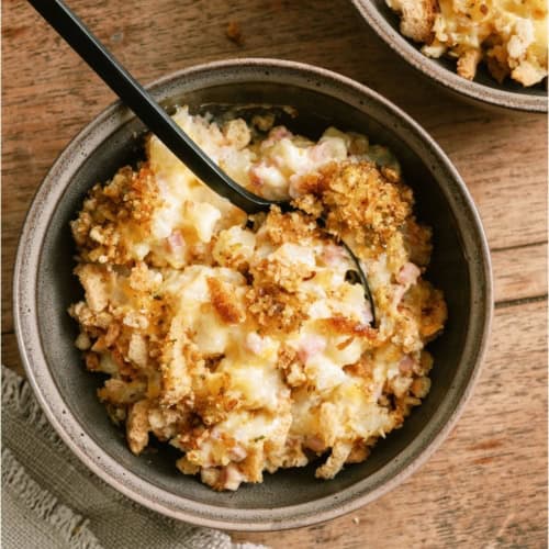Top view of a bowl with a serving of Slow Cooker Ham and Potato Casserole inside.