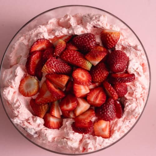 Top view of Strawberry Jello Fluff Salad with fresh sliced strawberries on top.