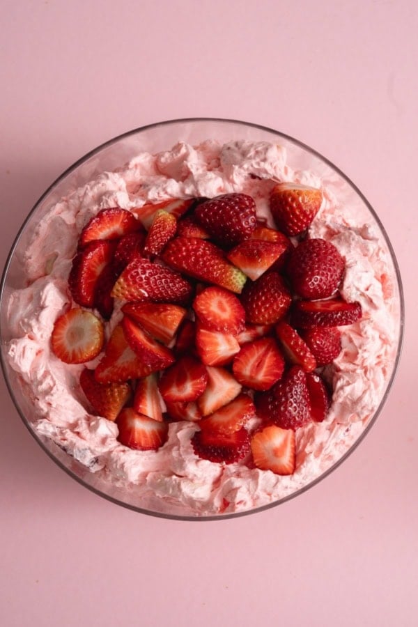 Top view of Strawberry Jello Fluff Salad with fresh sliced strawberries on top.