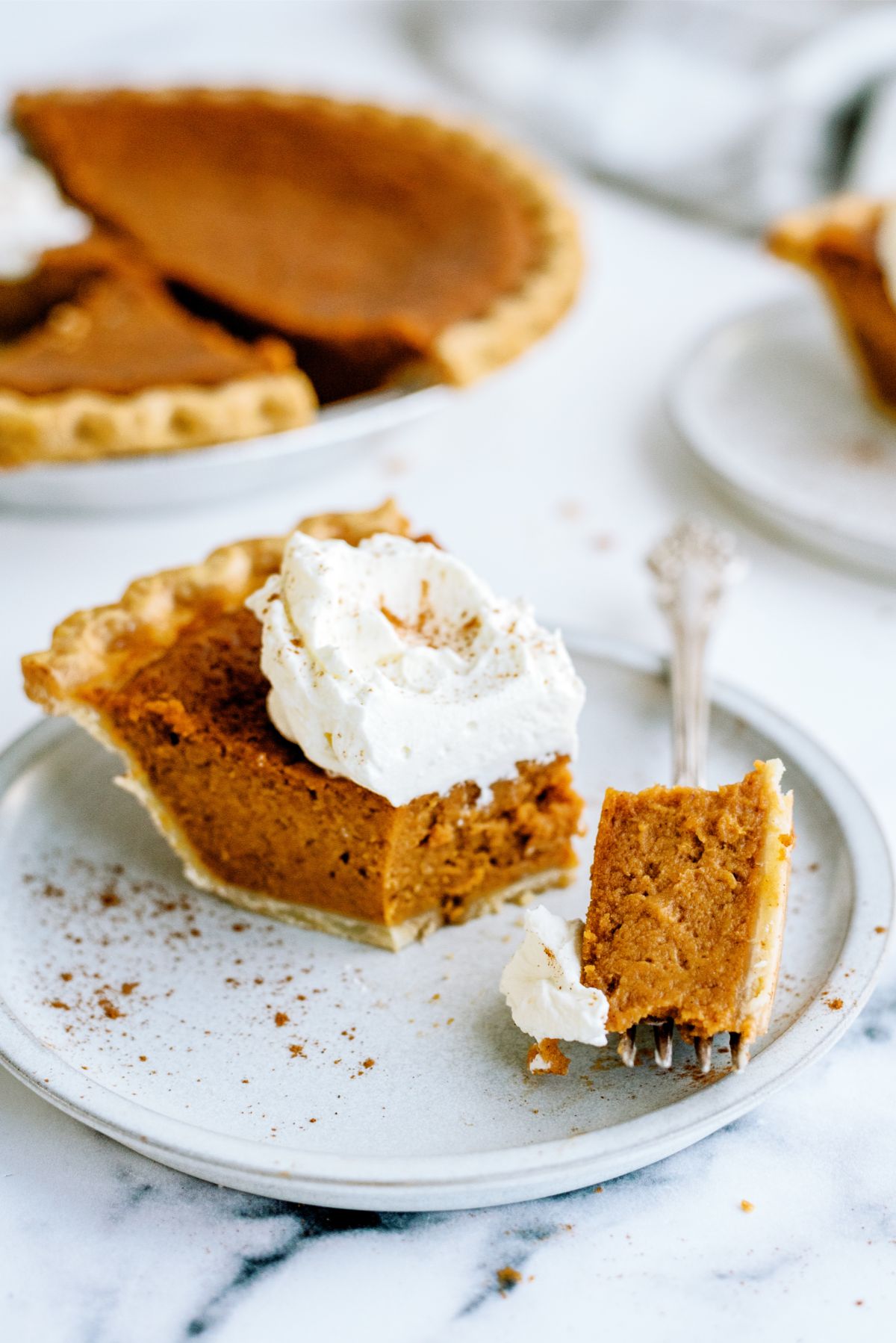 A slice of Sweet Potato Pie on a plate with a fork