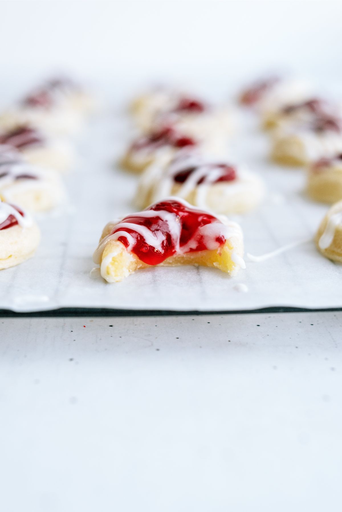 A close up of a Cherry Danish Cookie with a bite missing 