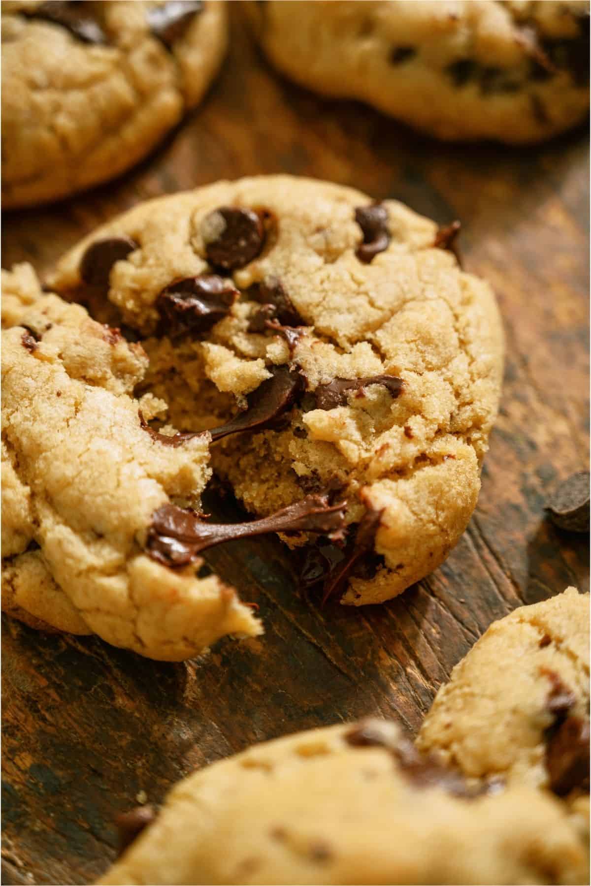 A Chewy Chocolate Chip Cookies broken in half to show the inside.