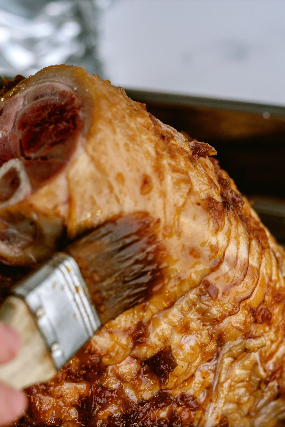Brushing glaze on baked ham