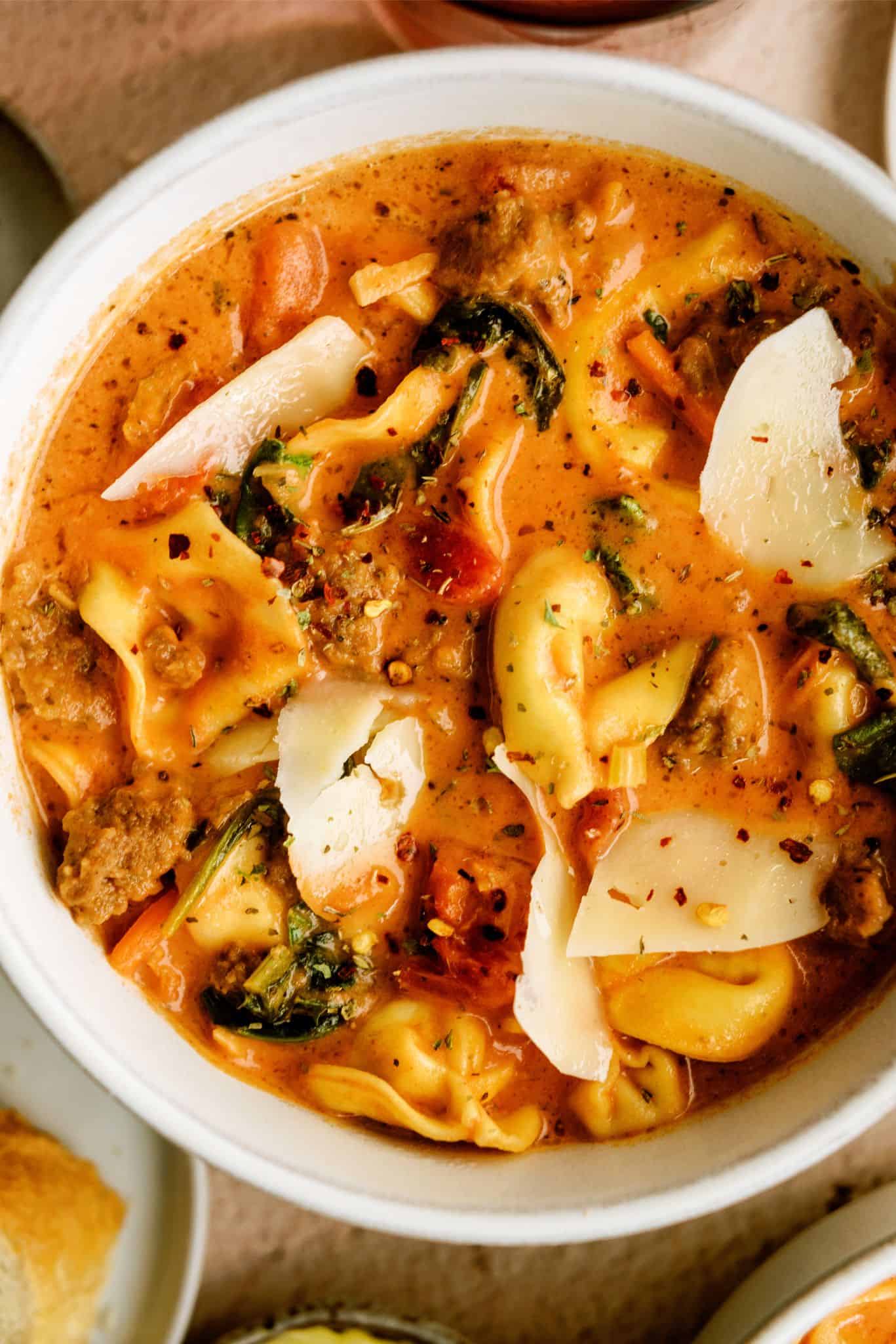 Close up top view of a bowl of Easy Sausage Tortellini Soup Recipe