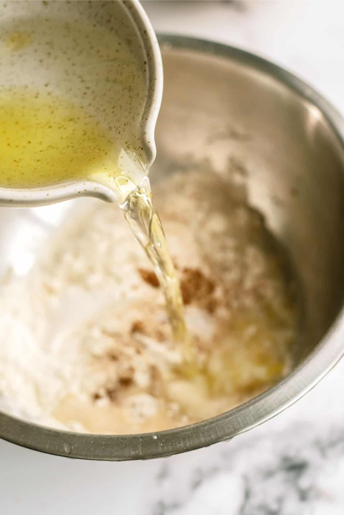 Adding oil and water to pizza dough