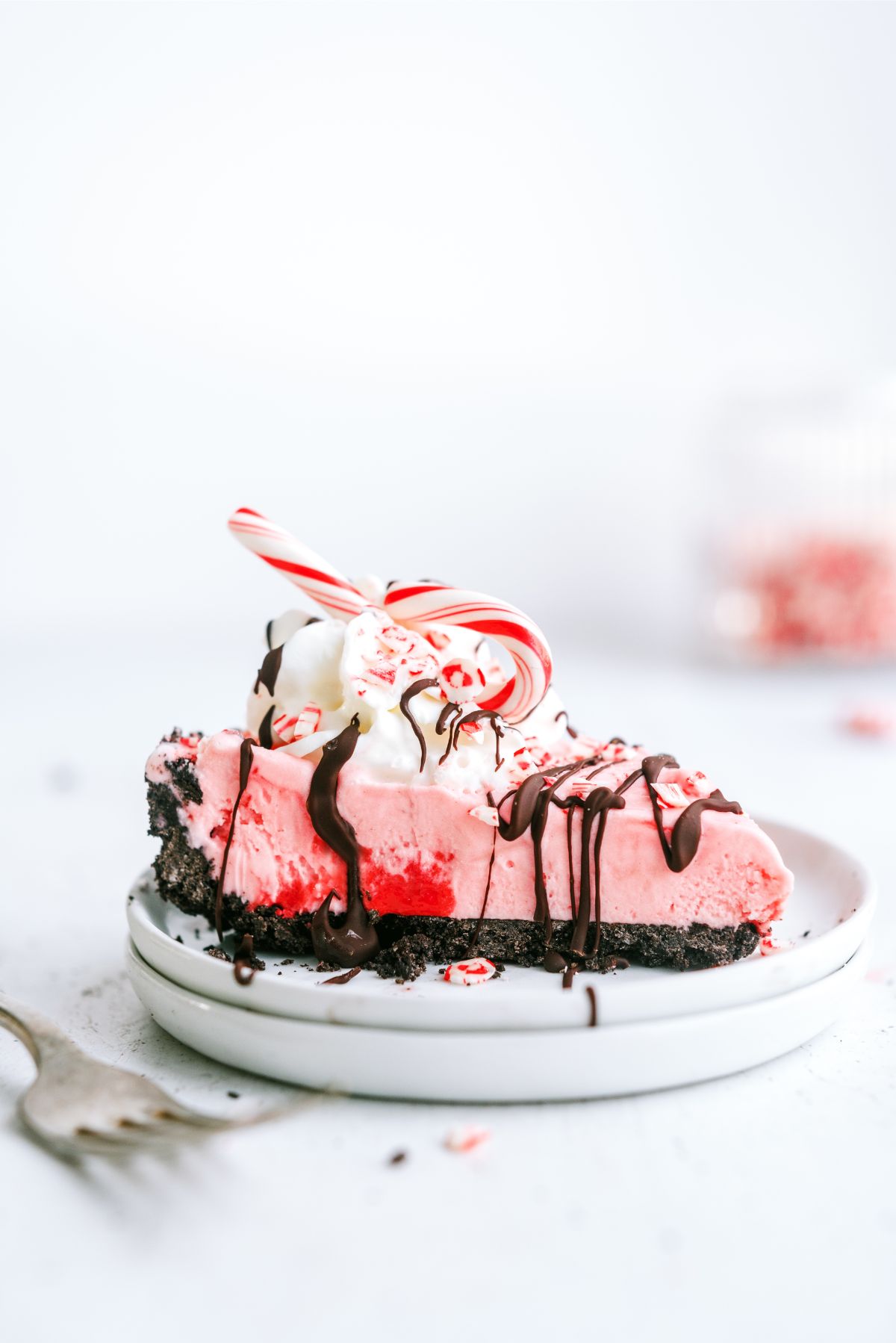 A slice of Peppermint Crunch Ice Cream Pie on a plate