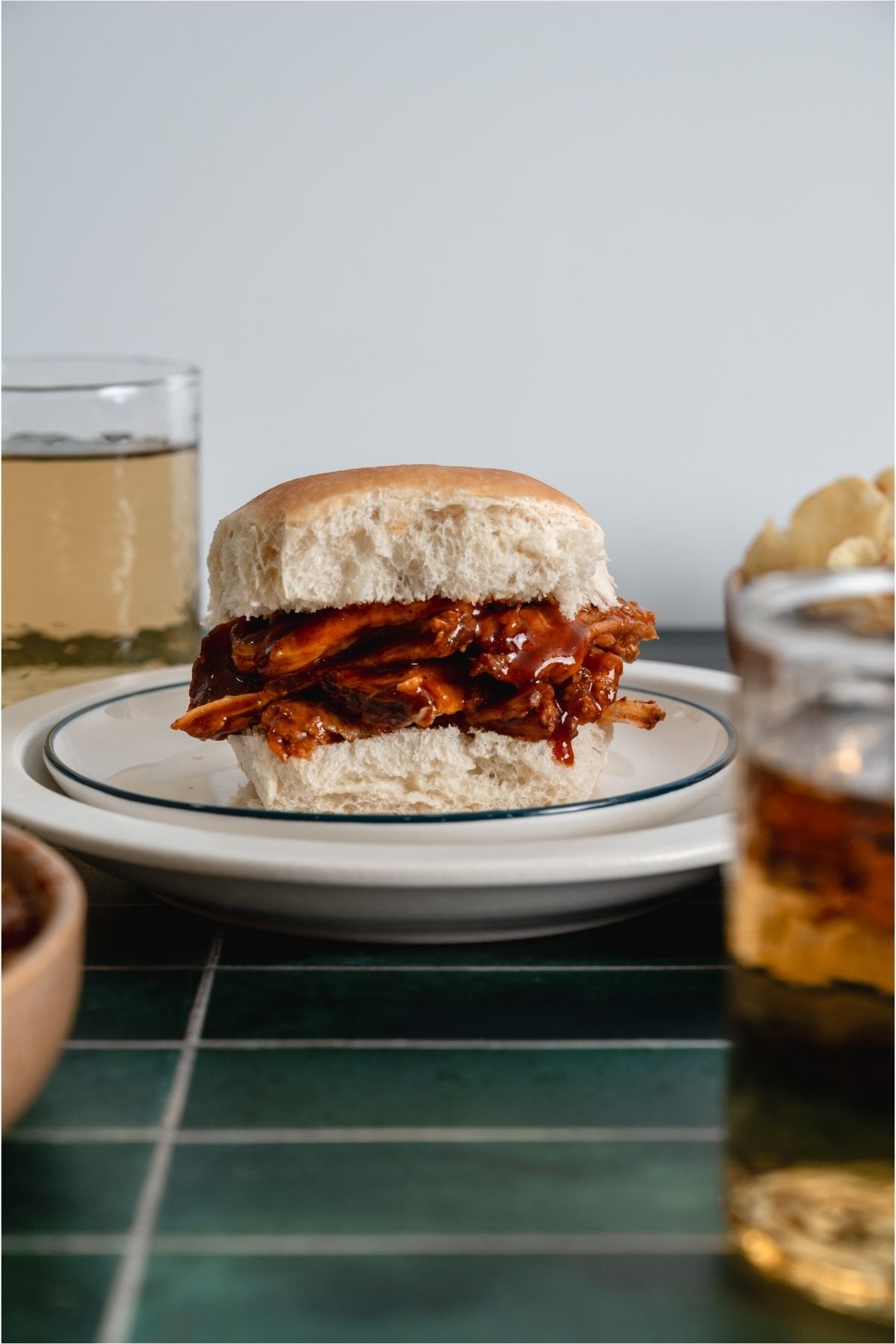 Slow Cooker Smoky BBQ Pulled Pork sandwich on a plate.