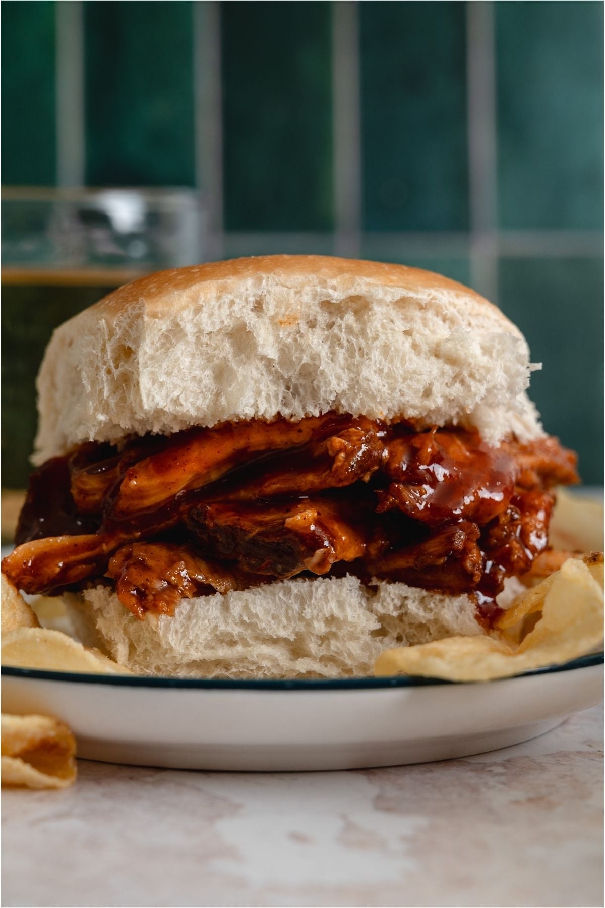 Slow Cooker Smoky BBQ Pulled Pork sandwich on a plate,