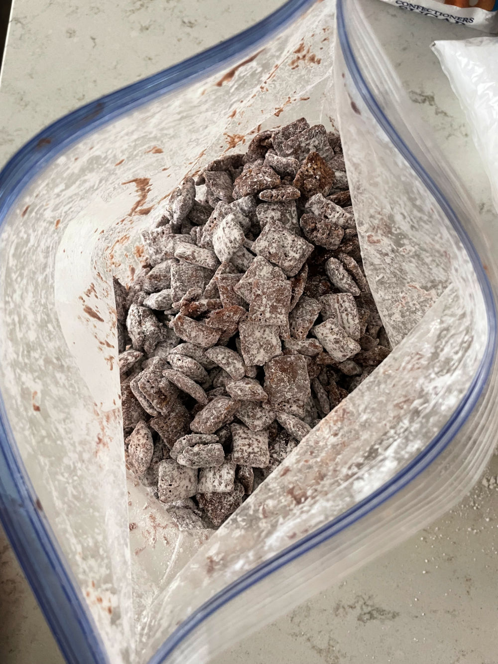 cereal coated with chocolate and powdered sugar in a plastic bag