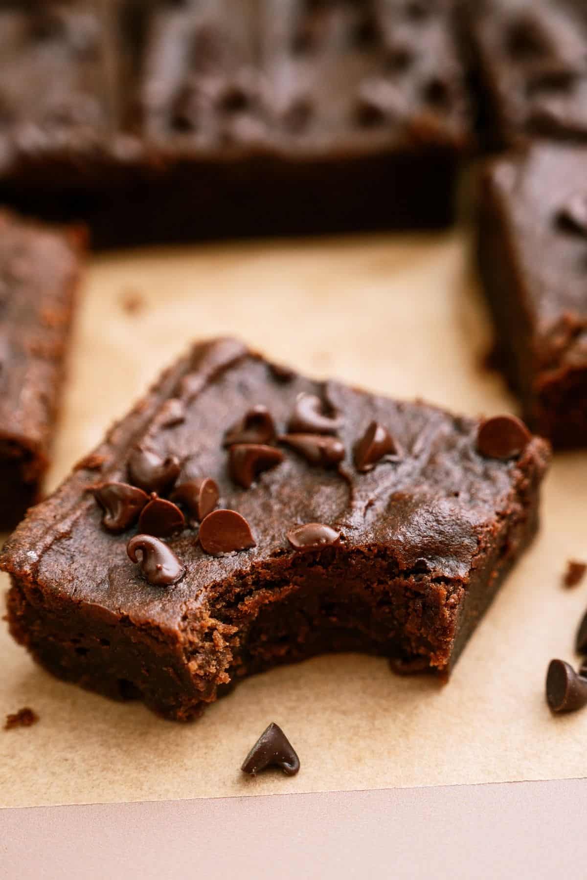 2 Ingredient Pumpkin Brownies with the brownie in front missing a bite.