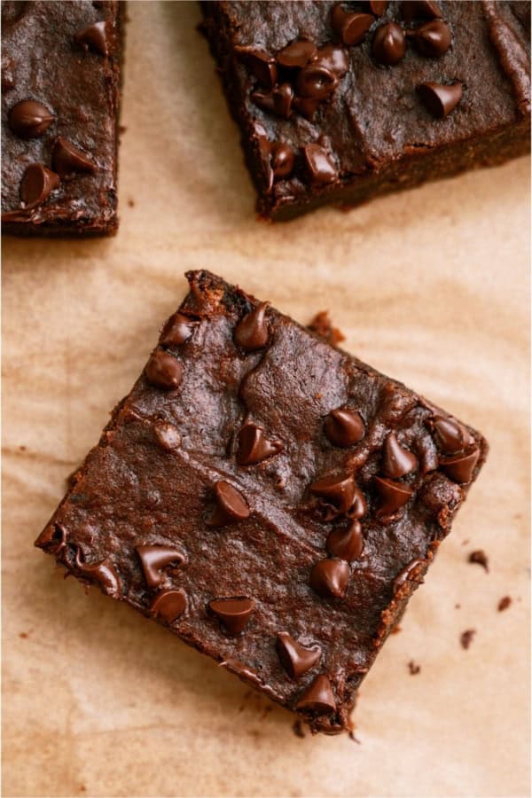 2 Ingredient Pumpkin Brownies cut into squares topped with chocolate chips.