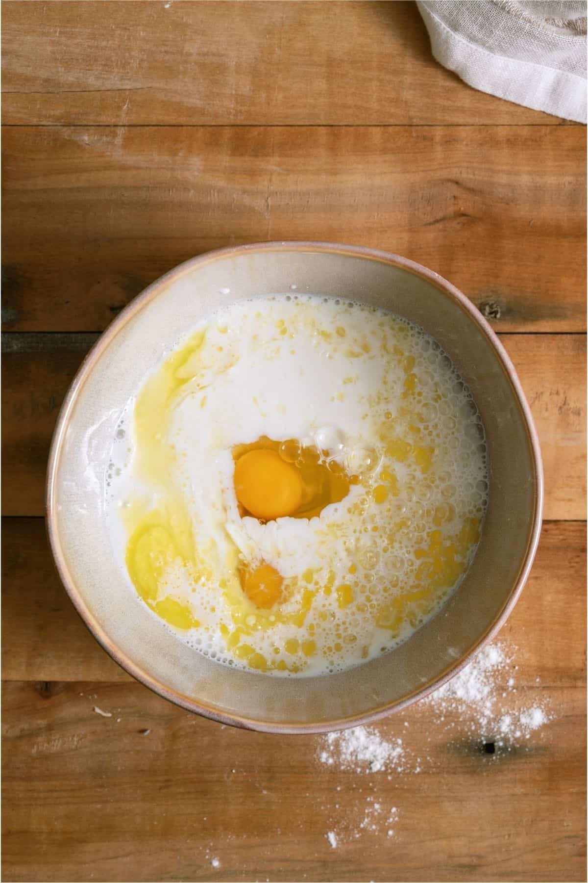 Add egg and melted butter to milk.