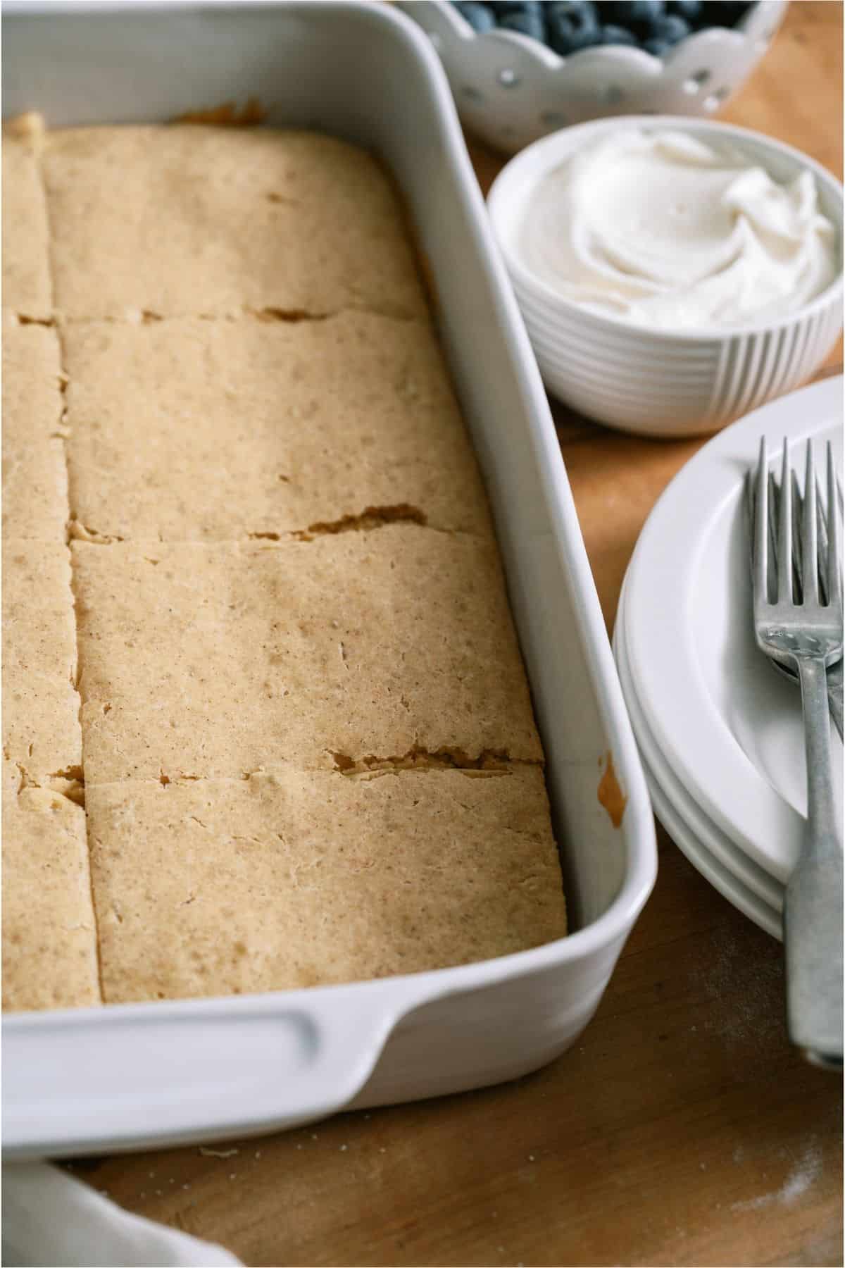 Baked Pancakes in a white baking dish cut into servings.
