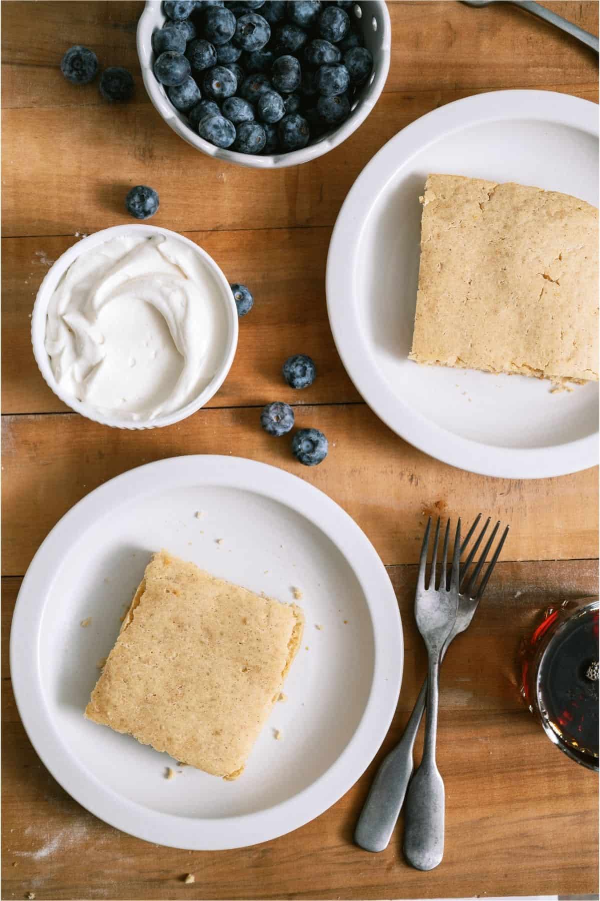 Two servings of Baked Pancakes on white plates.