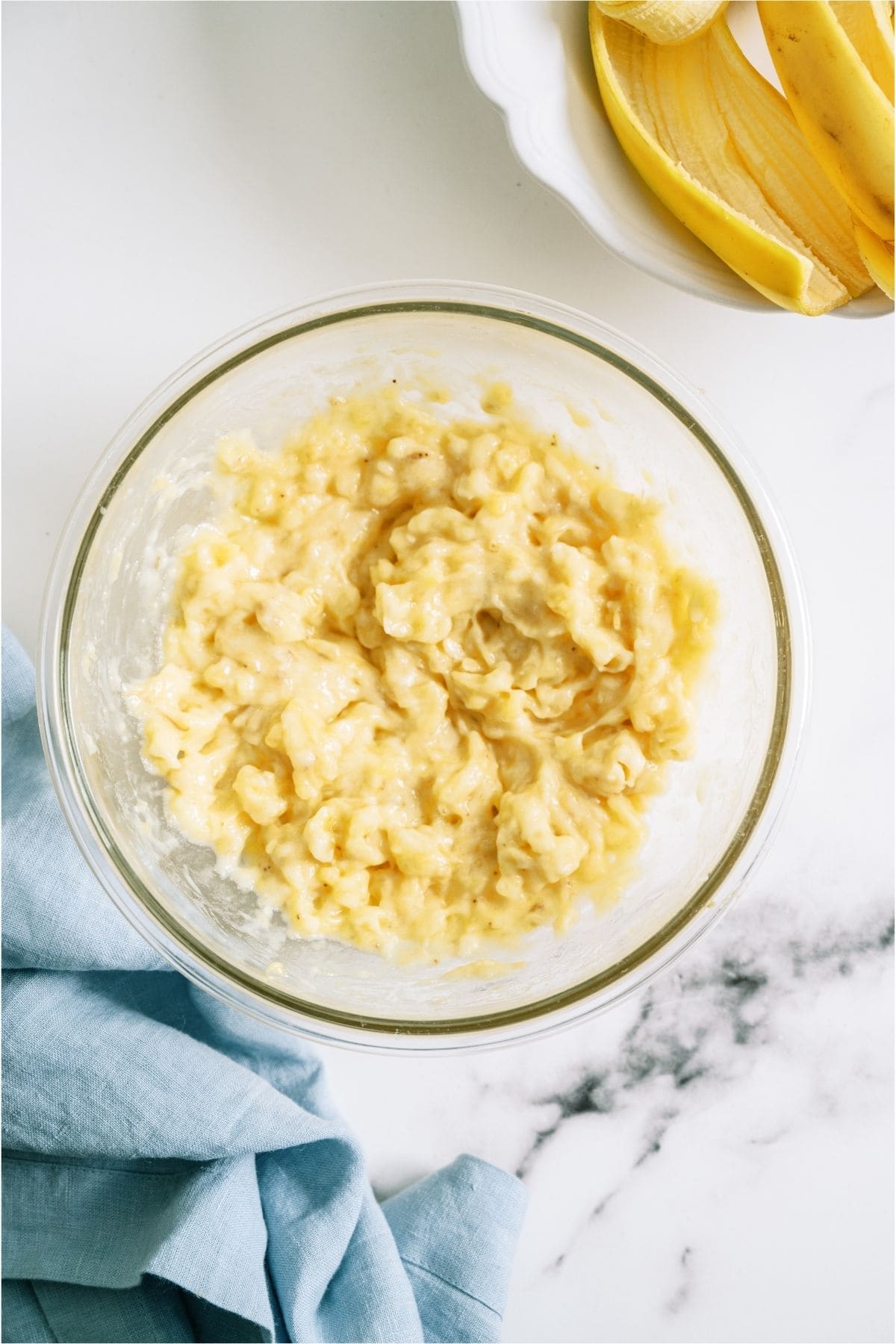 Mashed bananas in a mixing bowl.