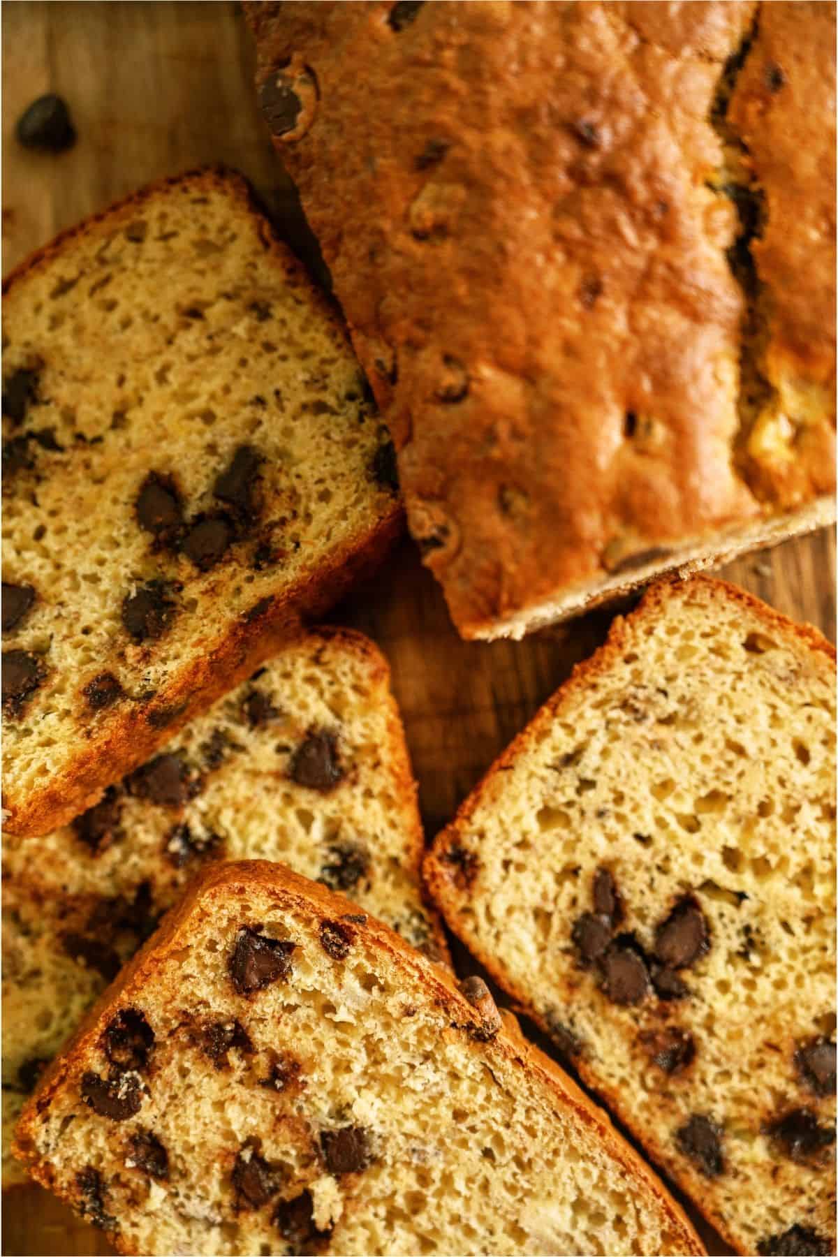 Top view of slices of banana bread and the remaining banana bread loaf on a cutting board.