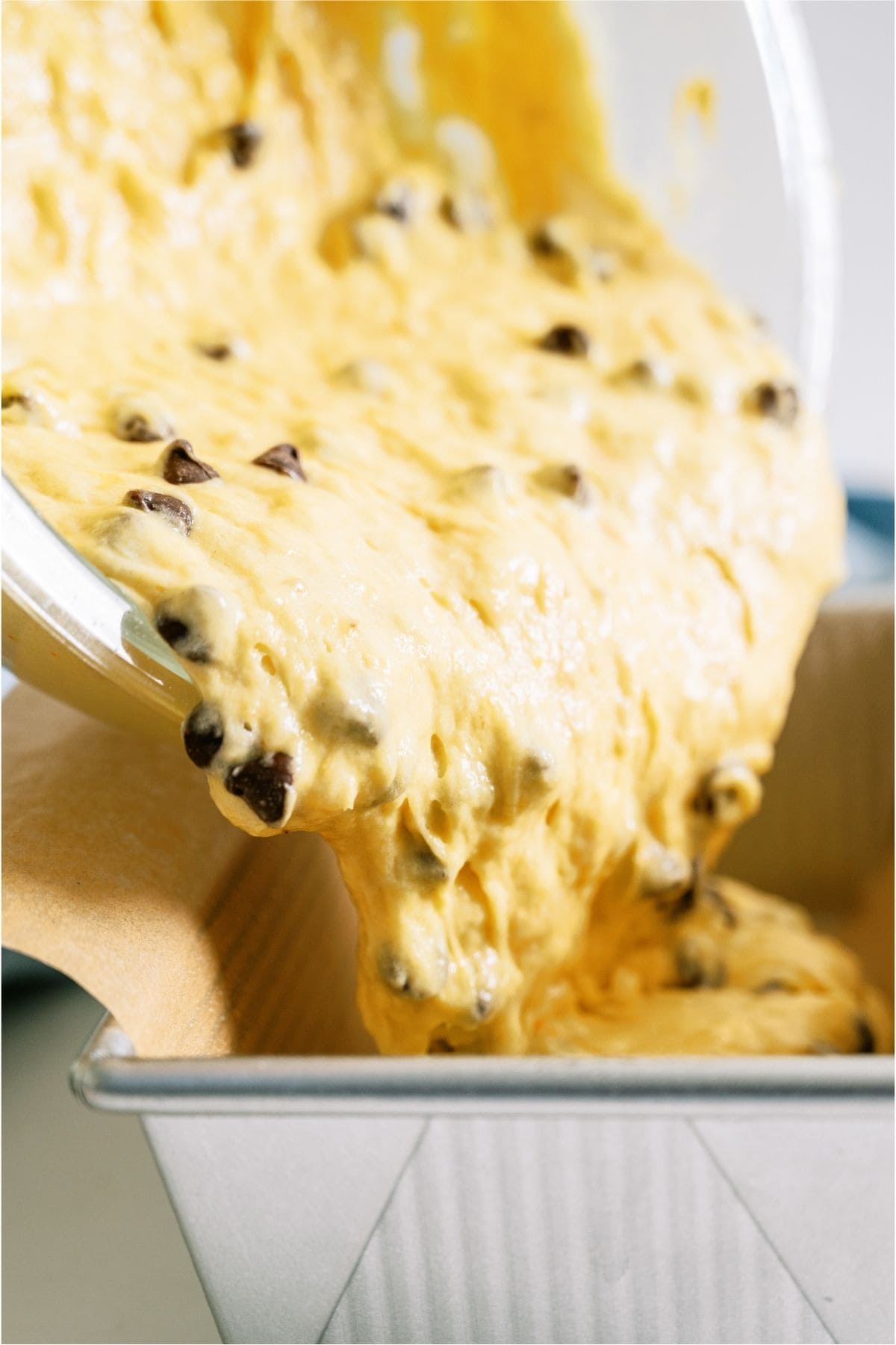 Pouring Banana Bread batter into prepared pan.