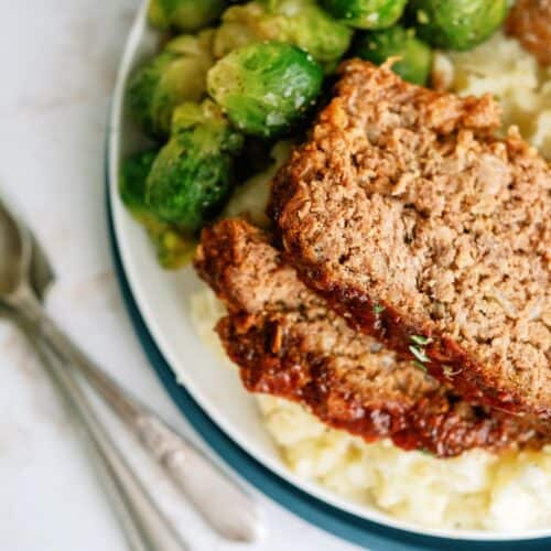 Homemade meatloaf served with Brussels sprouts and mashed potatoes.